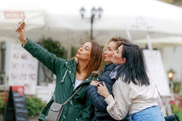 Digital gifts: Three women take a selfie and upload it to their travel blog